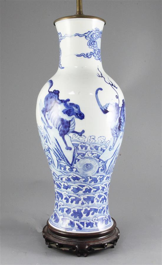 A Chinese blue and white mythical beasts baluster vase, late 19th century/early 20th century, 45cm excluding wood stand and later lam